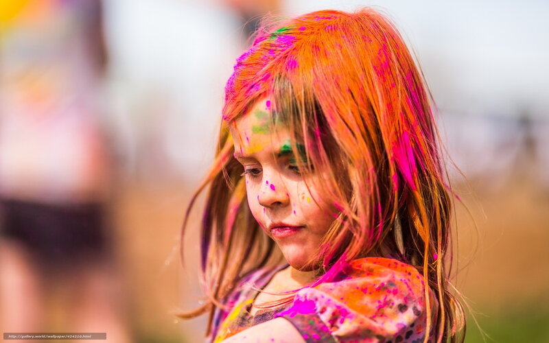 child covered in colorful powder