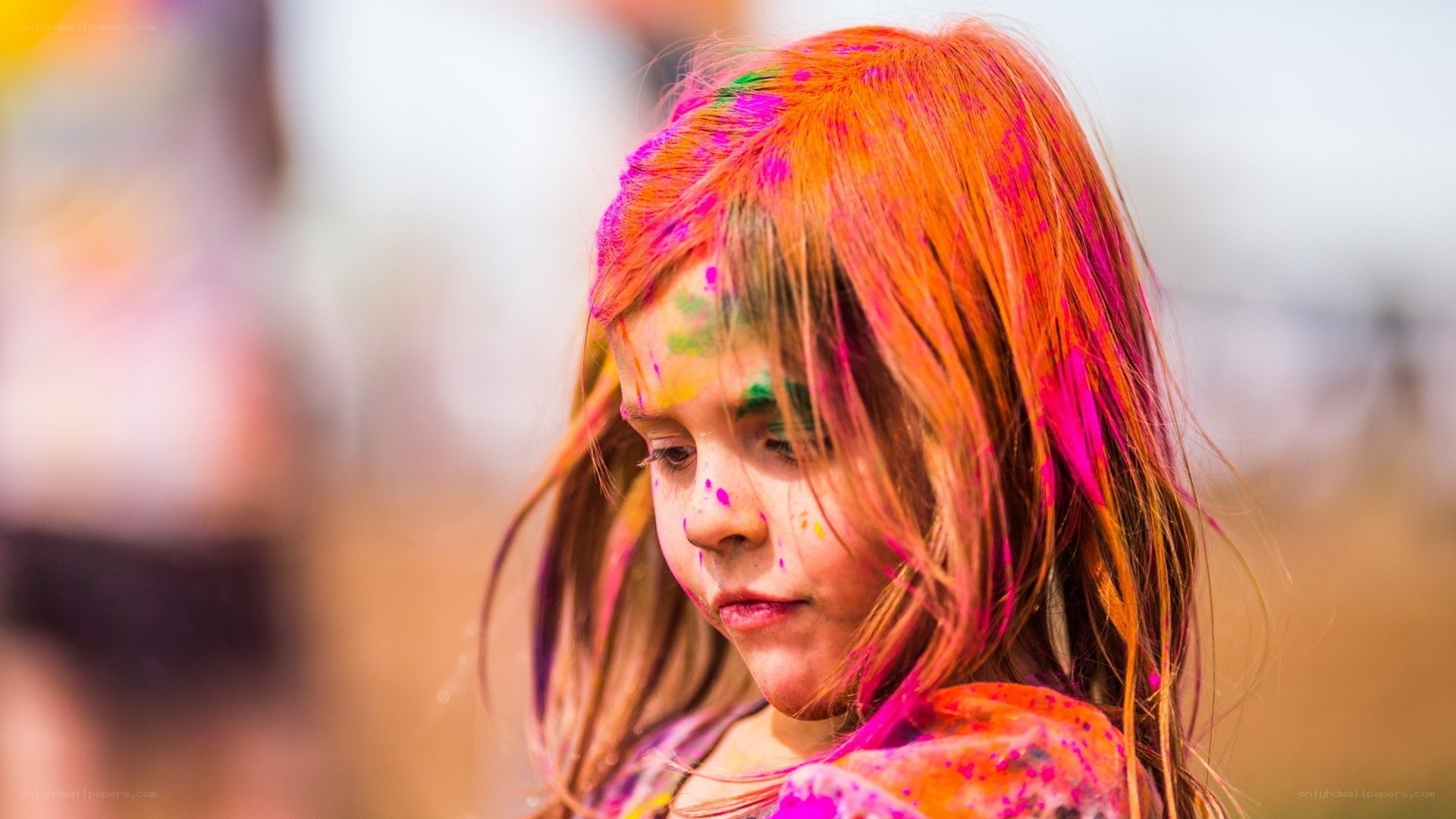 child covered in colorful powder