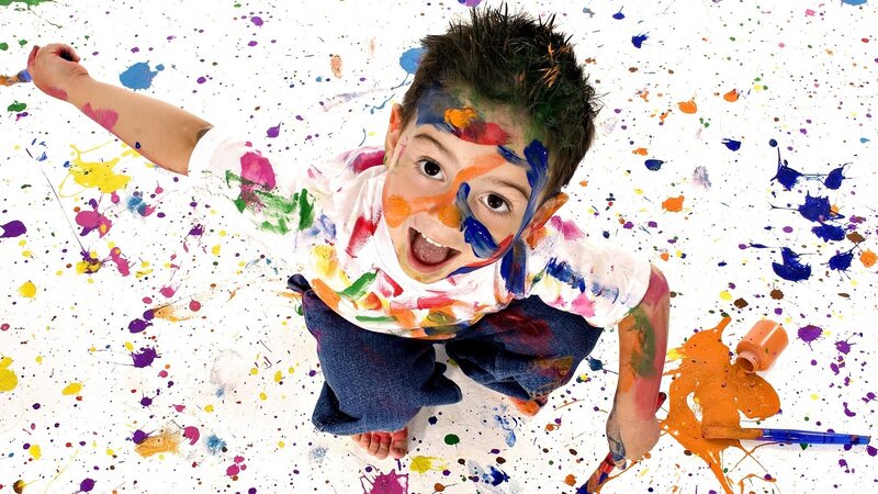 child covered in paint splatters