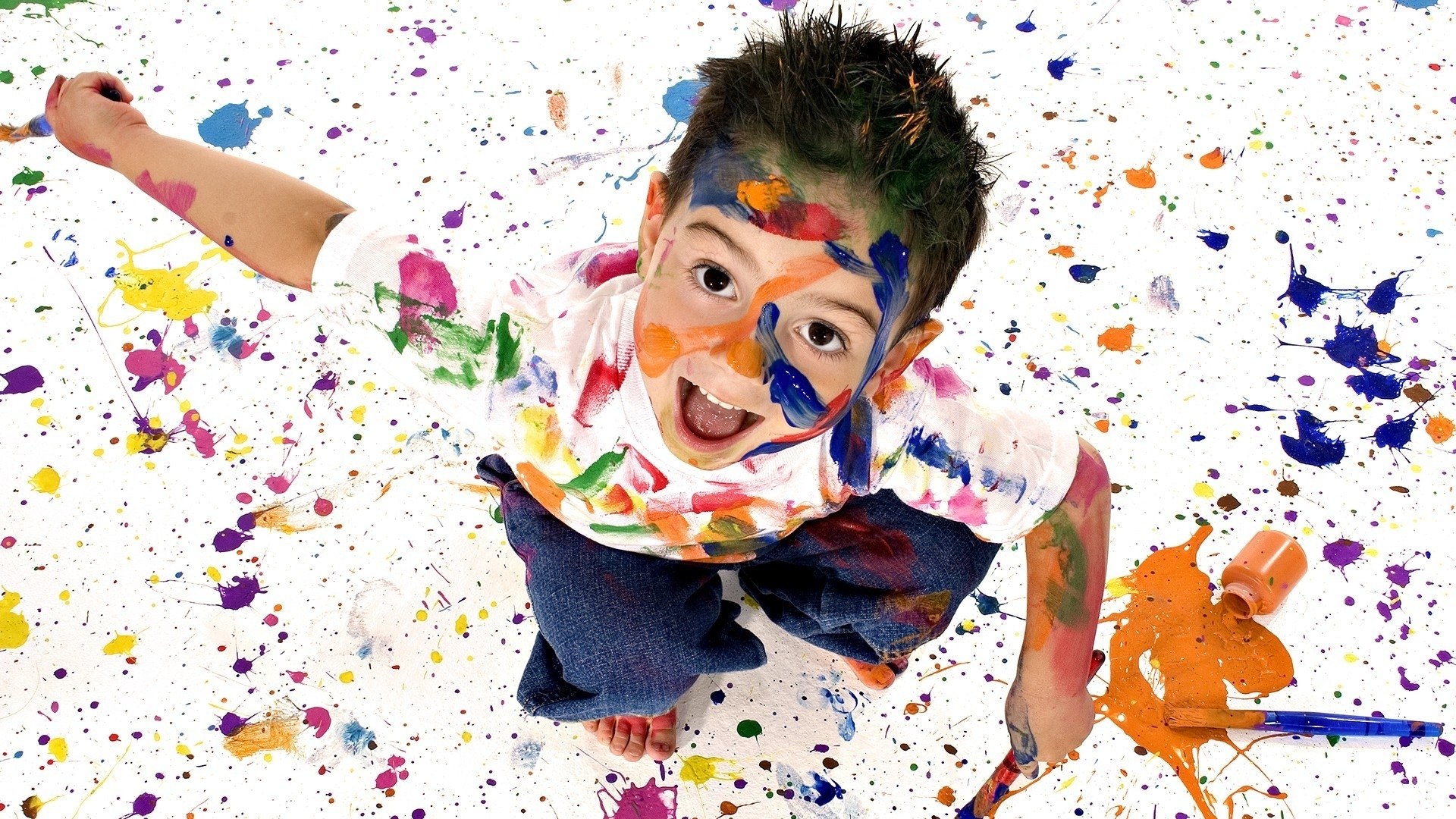 child covered in paint splatters