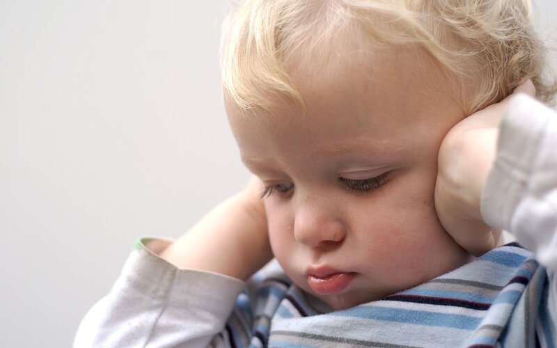 child covering ears