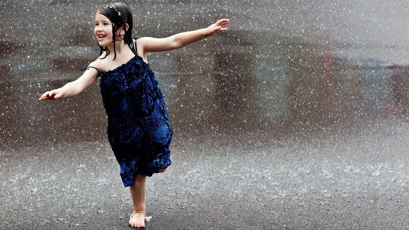 child dancing in the rain