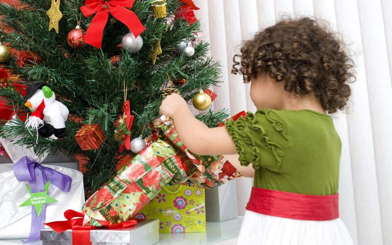 Child Decorating Christmas Tree — Green