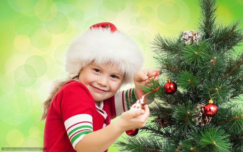 child decorating christmas tree