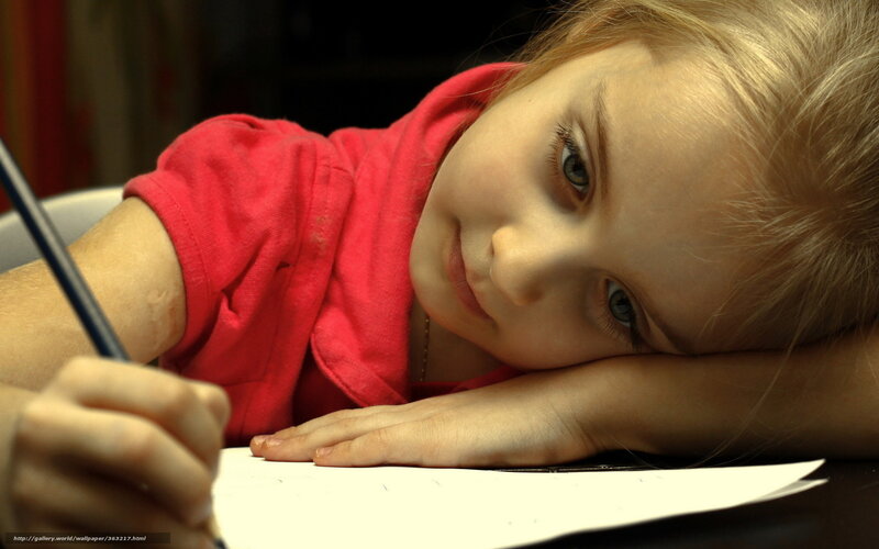 child drawing at desk