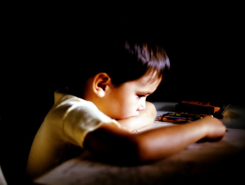 child drawing at night