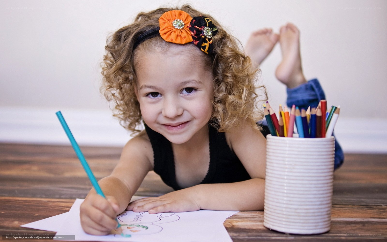 child drawing with colored pencils