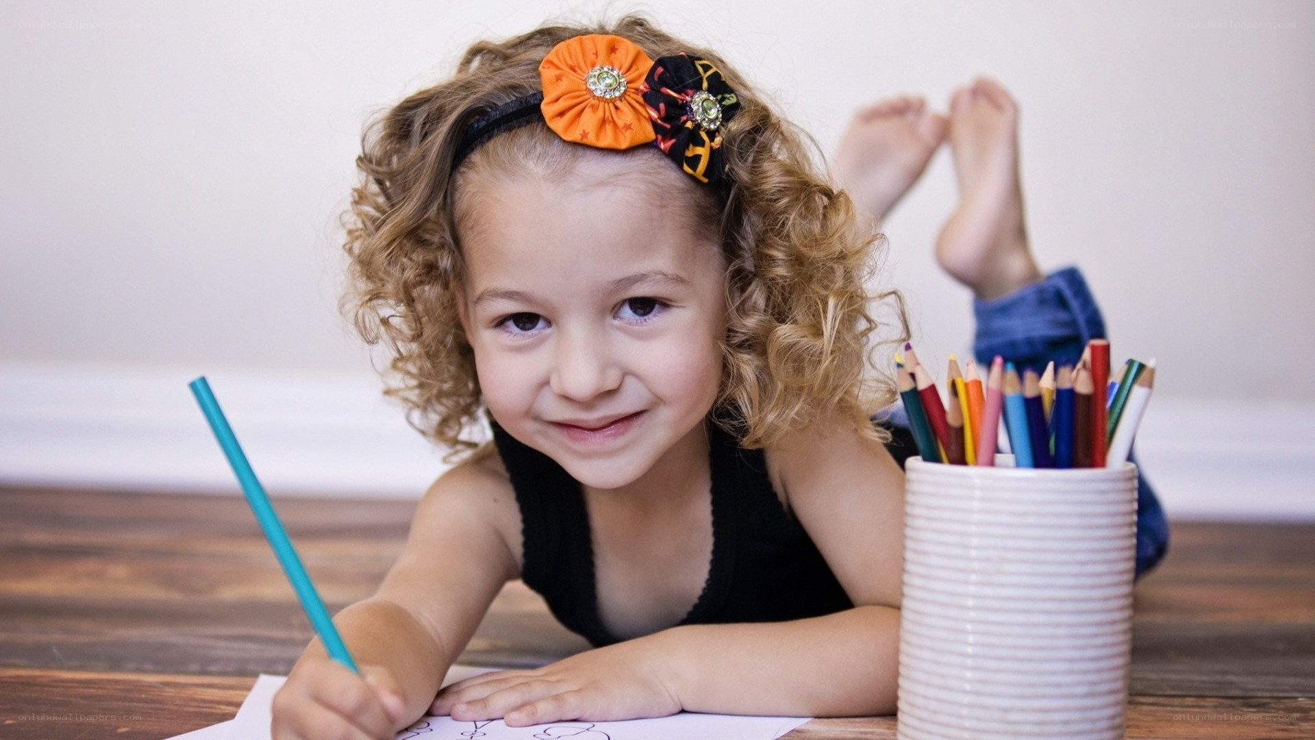 child drawing with colored pencils