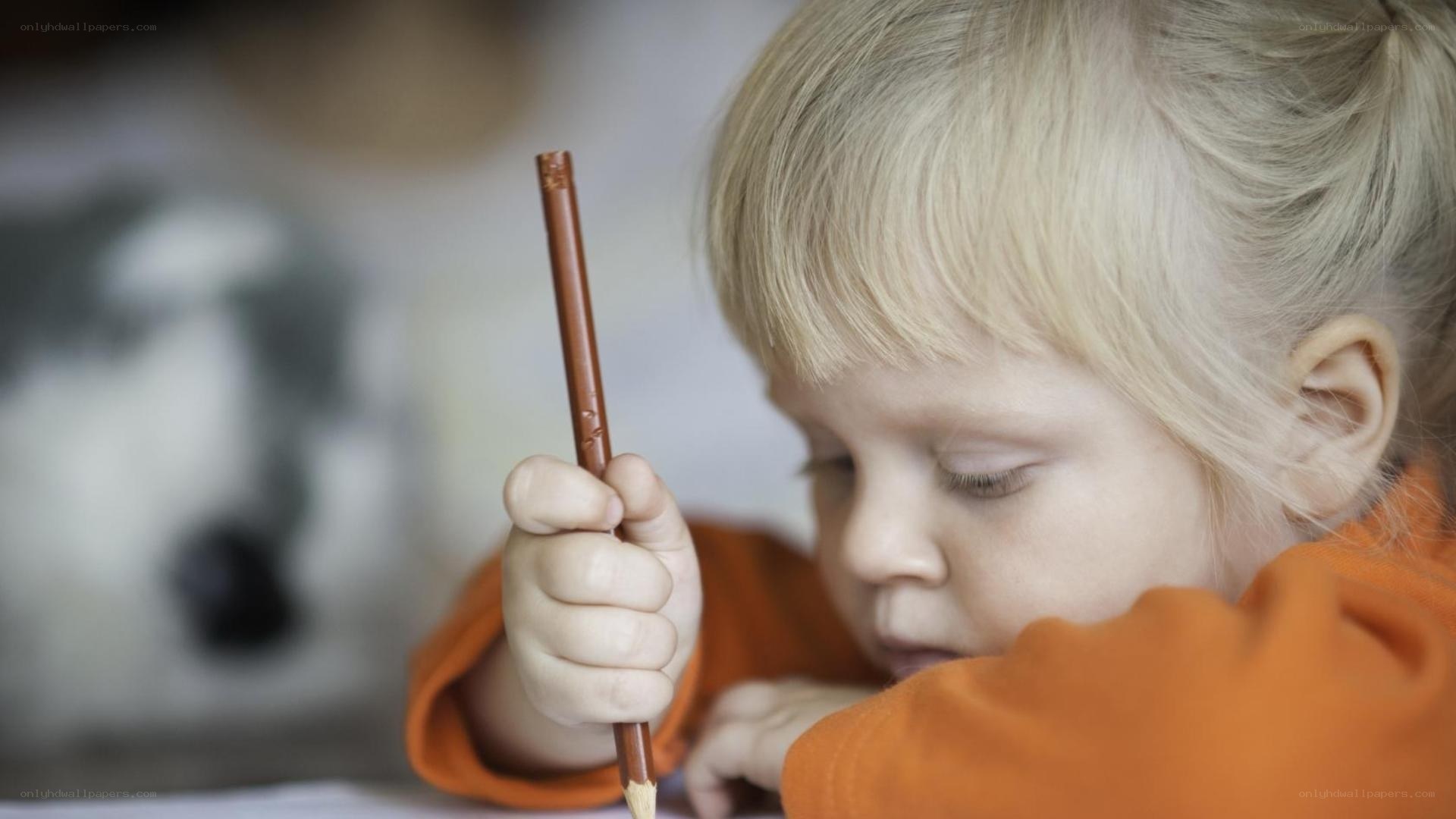 child drawing with pencil