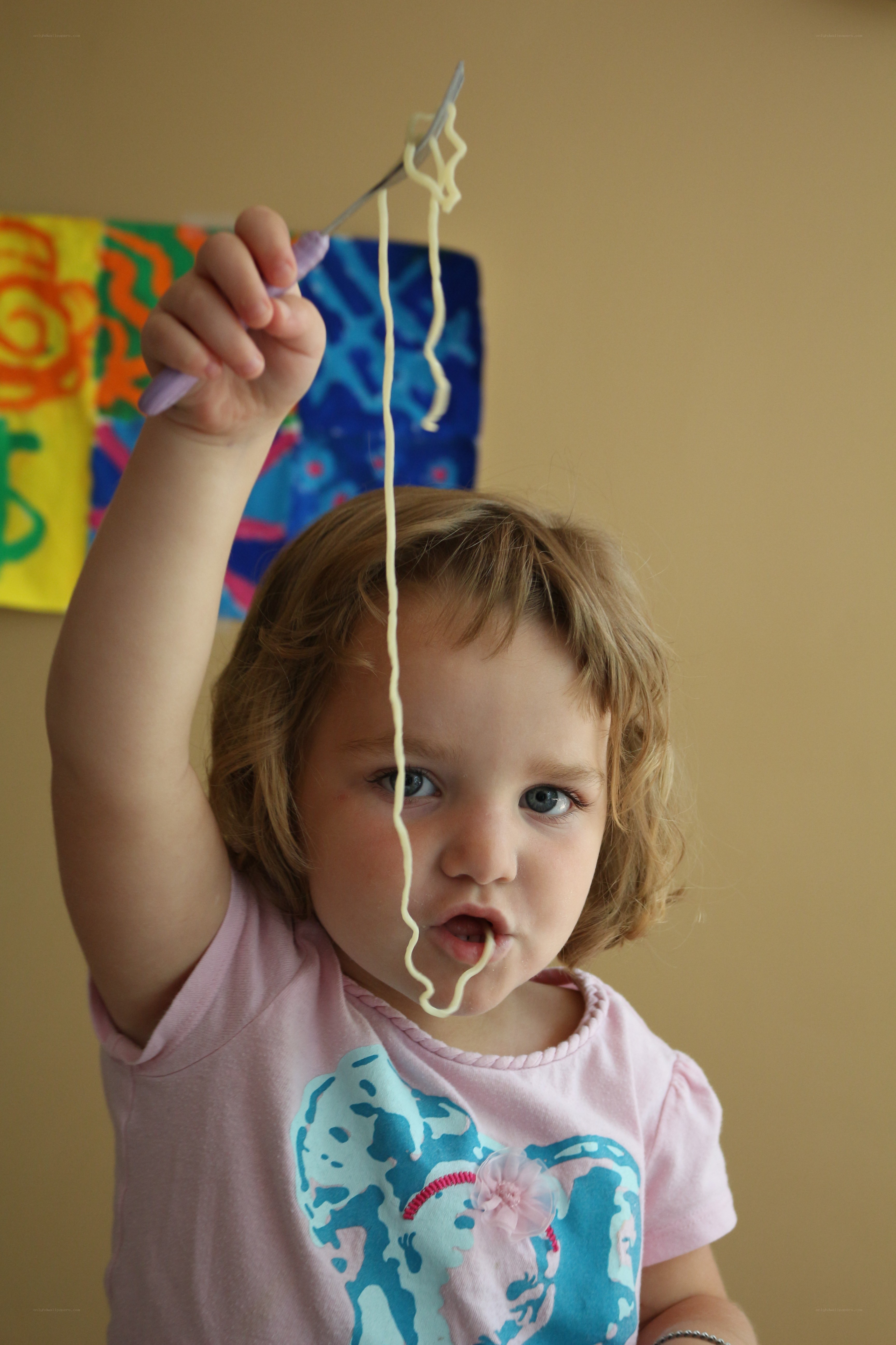 child eating spaghetti with fork