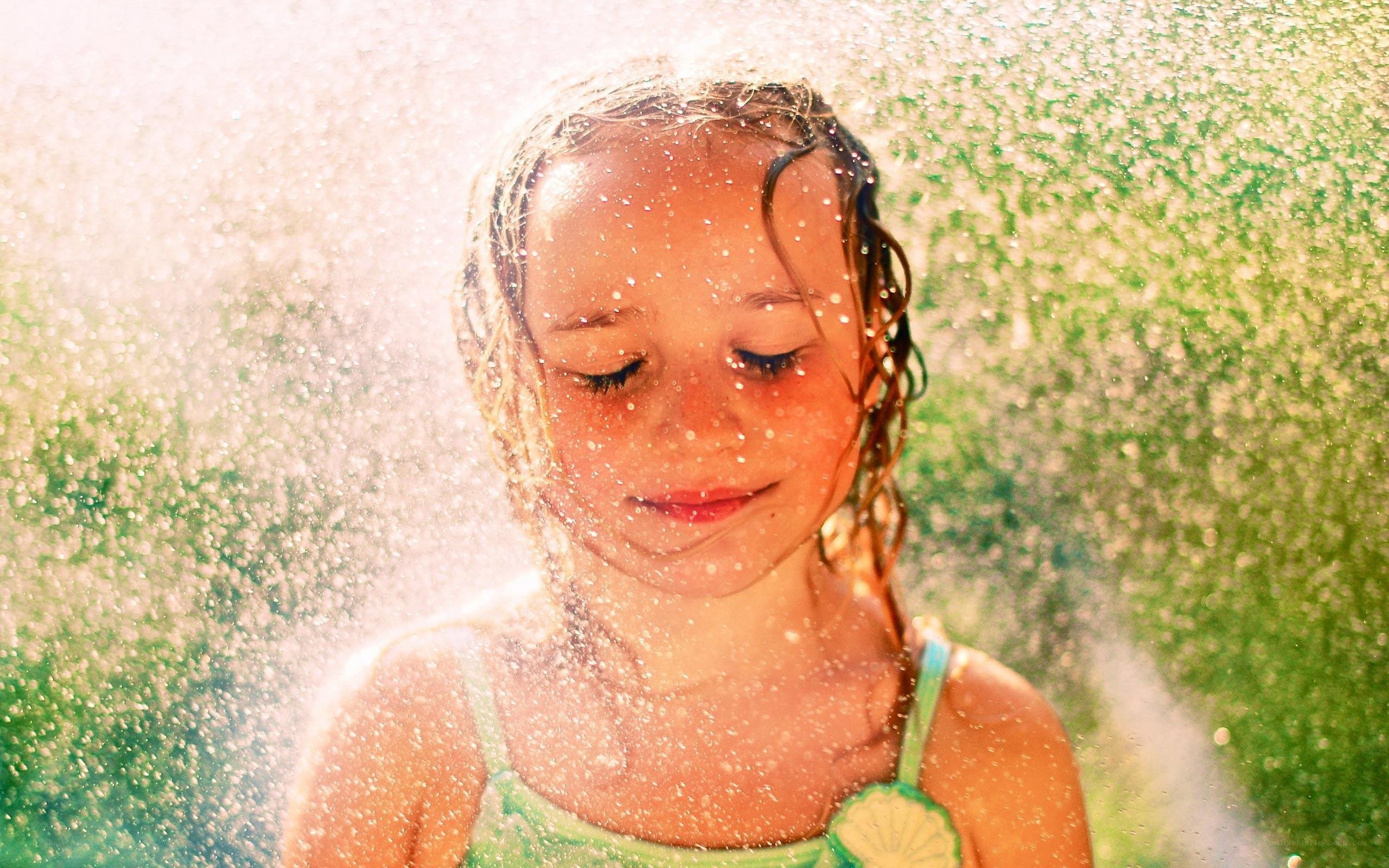 child enjoying water spray