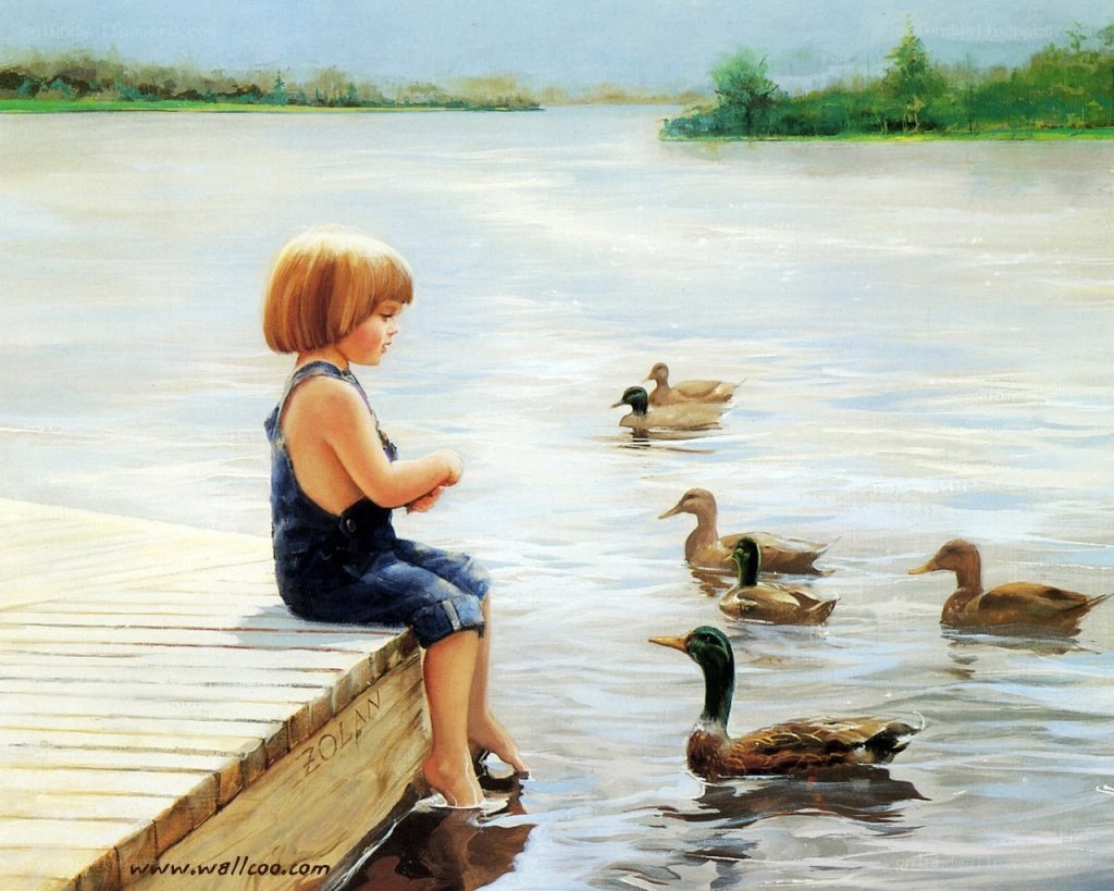 Child feeding ducks by a lake