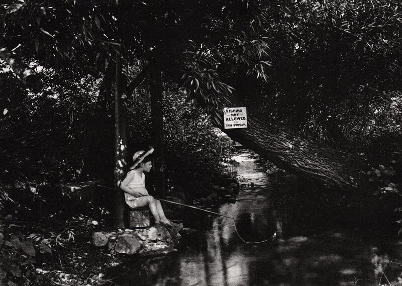 Child fishing by stream