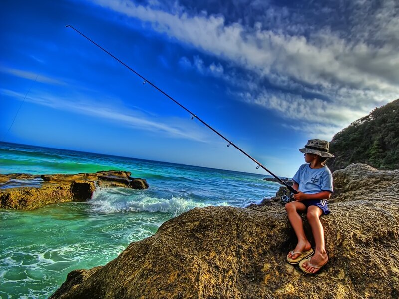 Child Fishing on Rocks — Blue