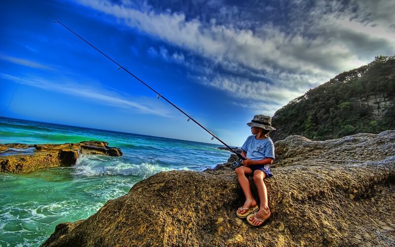 Child Fishing on Rocks