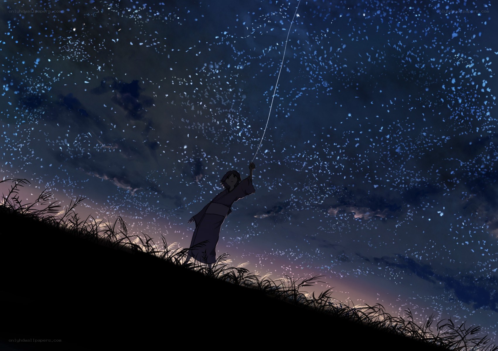 child flying kite at night