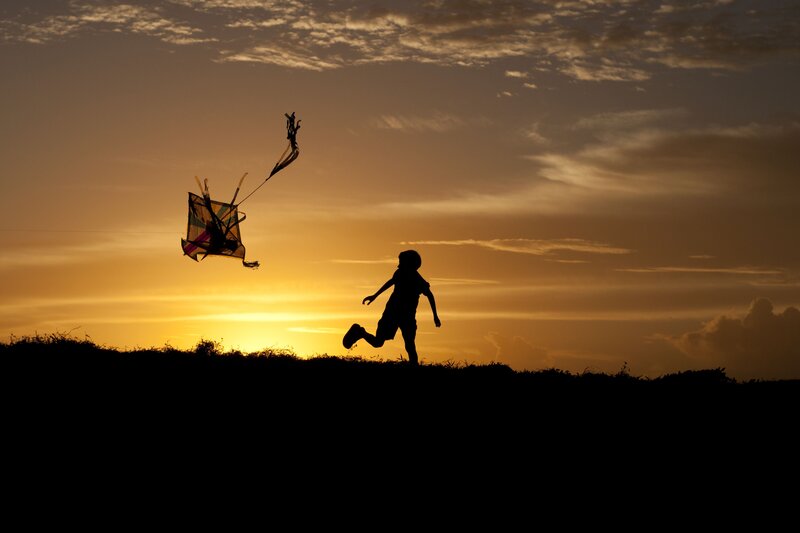 Child Flying Kite — Orange, Serene, Sunset