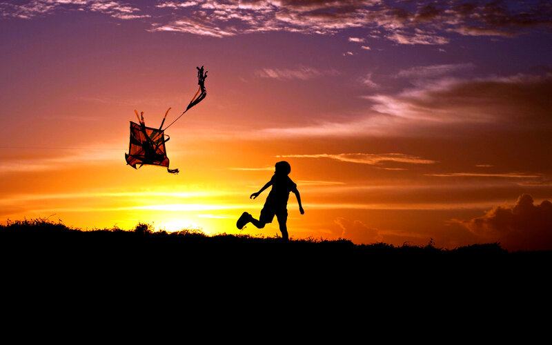 Child Flying Kite — Orange