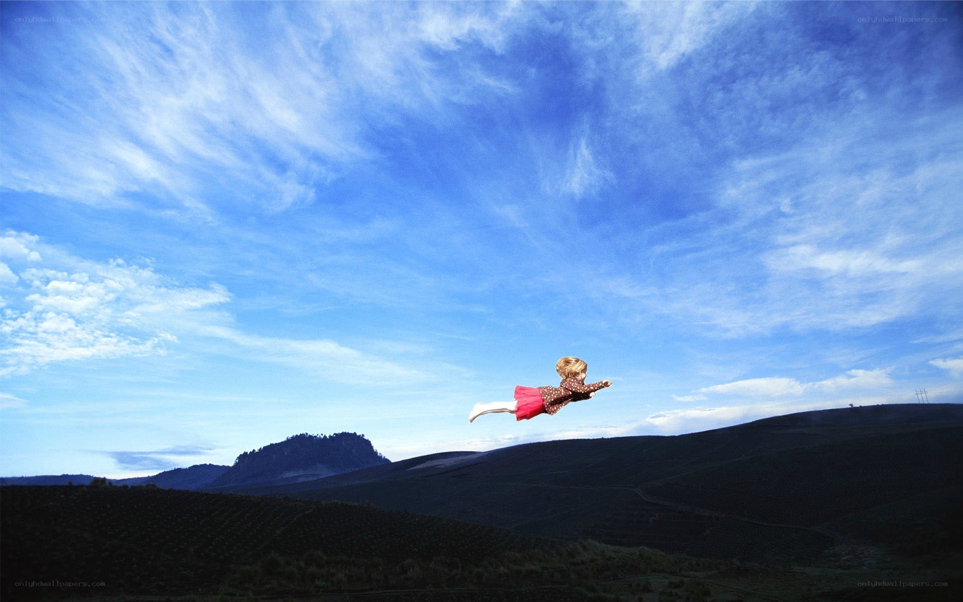 Child flying over hills