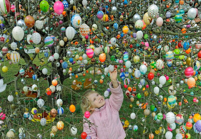 Child Hanging Easter Eggs