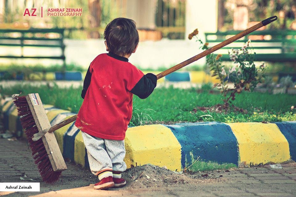 child holding a broom