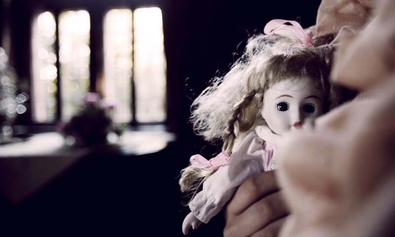 child holding a doll