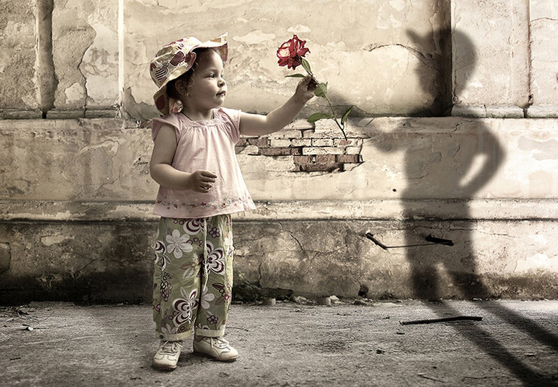 Child holding a rose