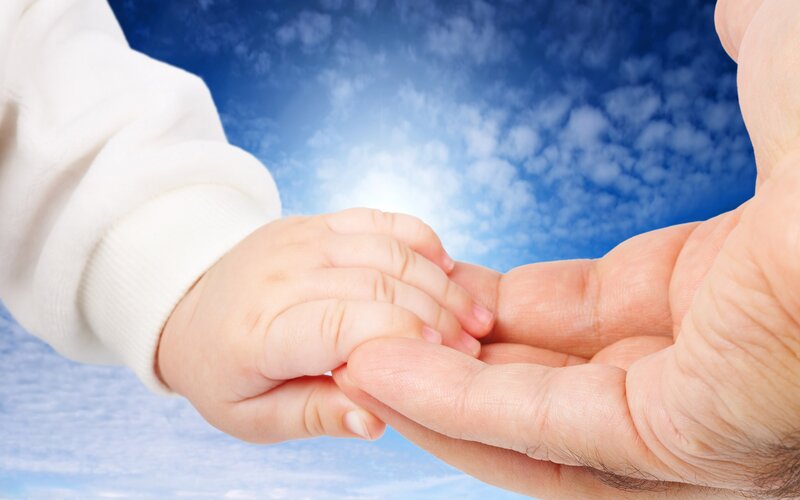 child holding adult hand