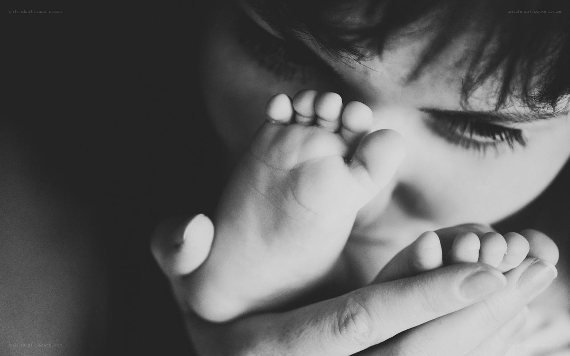 child holding baby feet