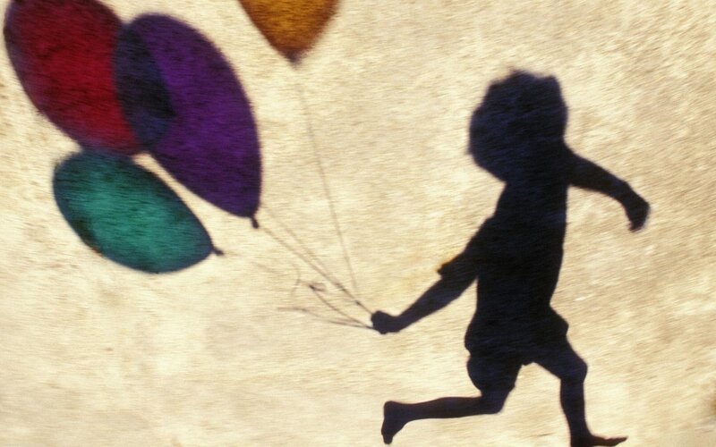 Child Holding Balloons — Black, Playful