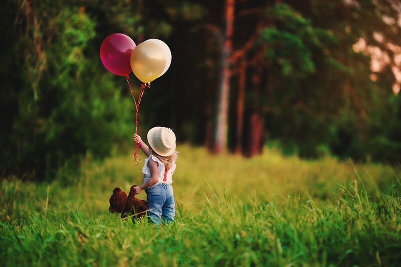 Child Holding Balloons — Green, Serene, Afternoon