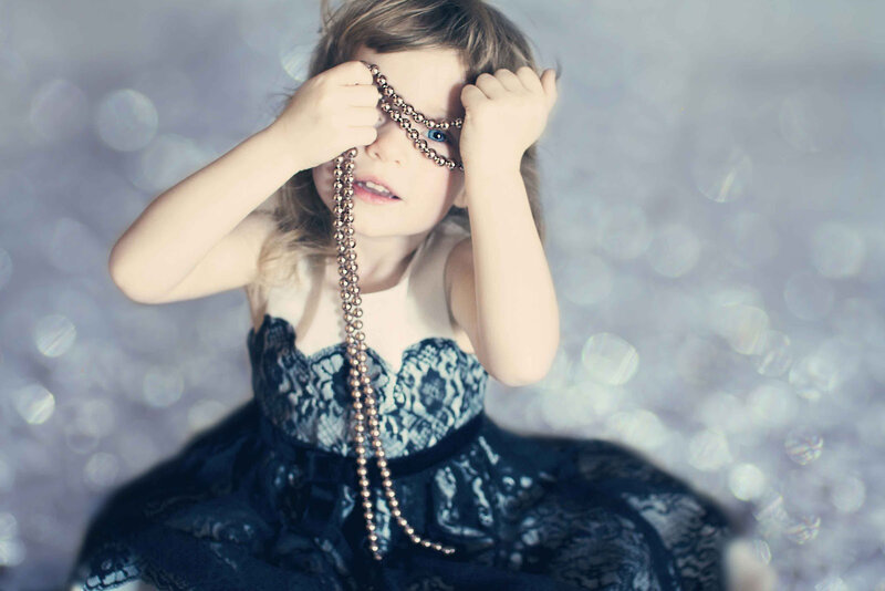 Child Holding Beads