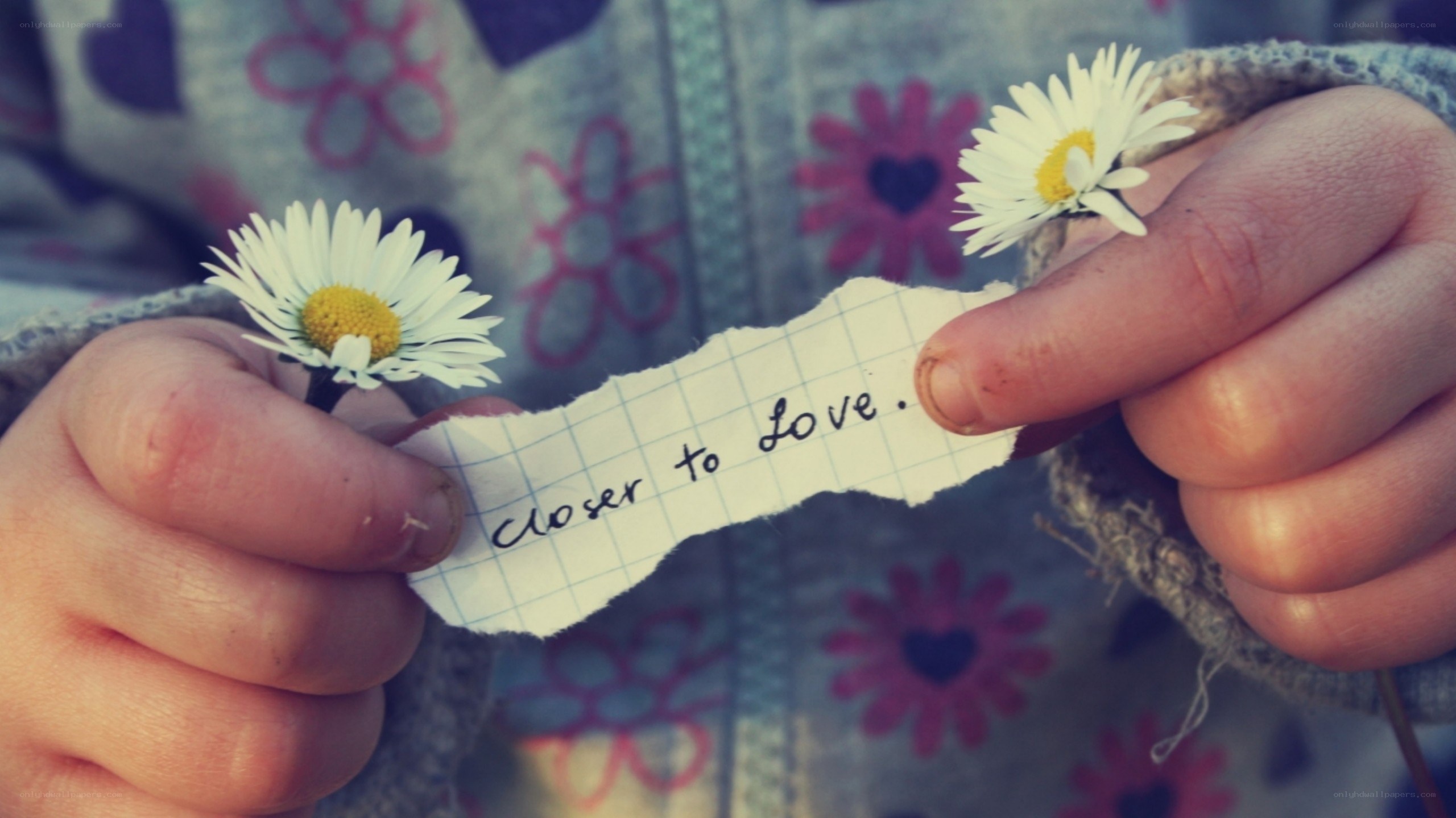 child holding daisies and note