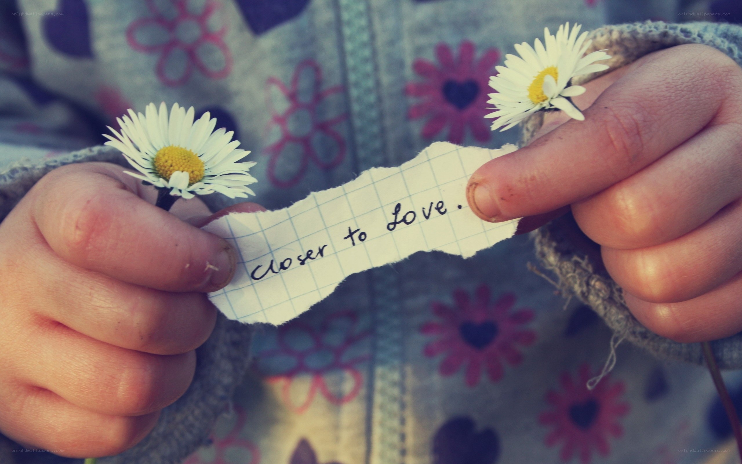 child holding daisies and note