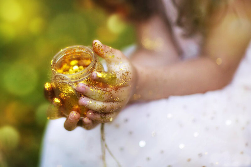 Child Holding Glitter Jar