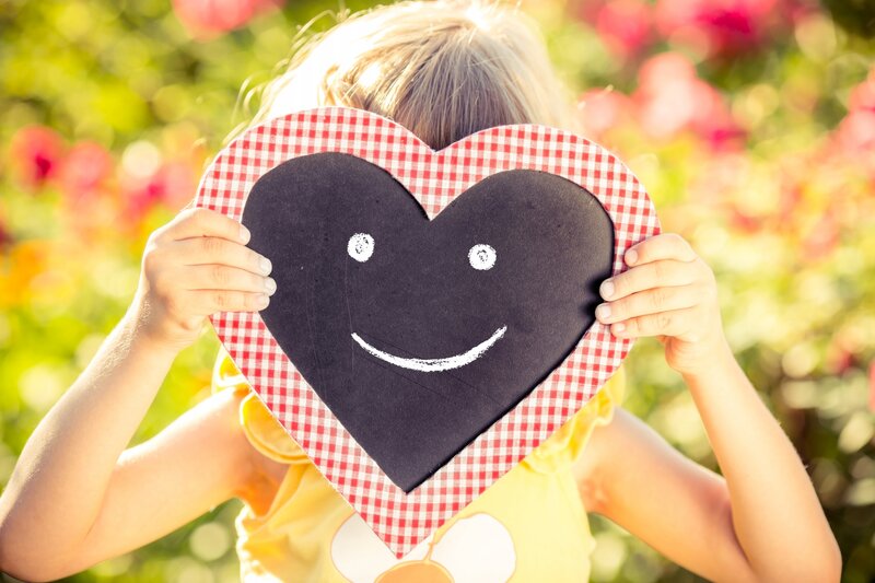 Child Holding Heart — Yellow