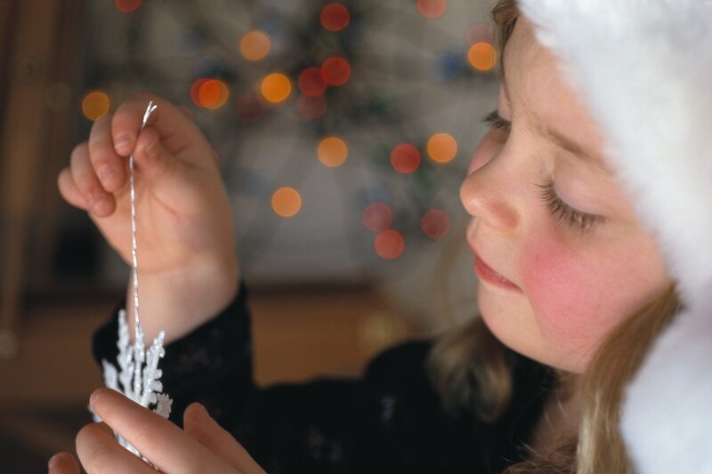 Child Holding Ornament — White, Festive