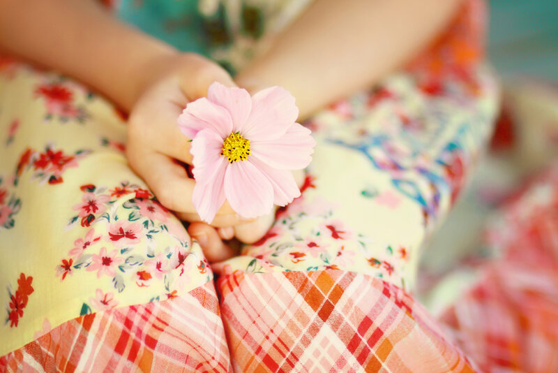Child Holding Pink Flower