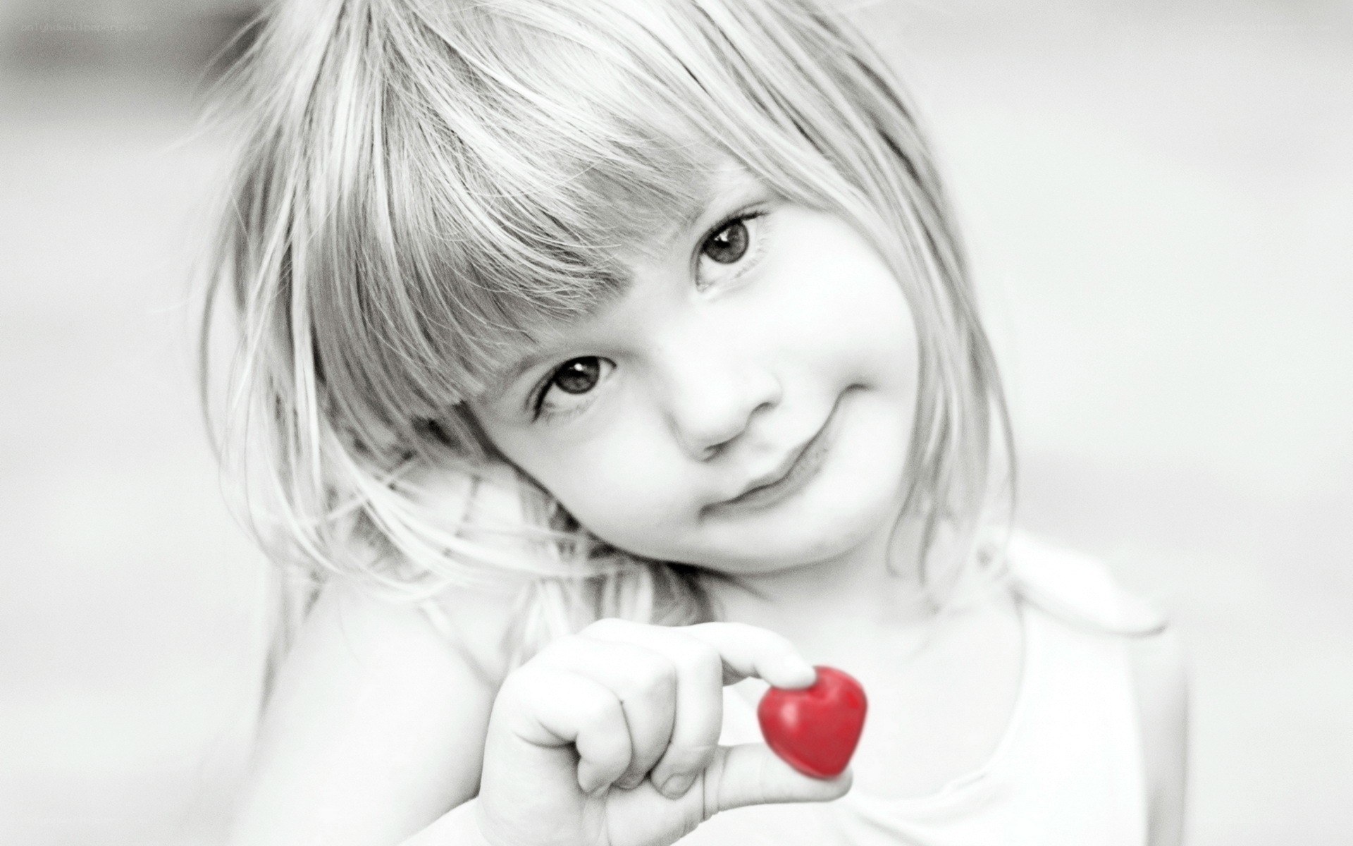 child holding red heart