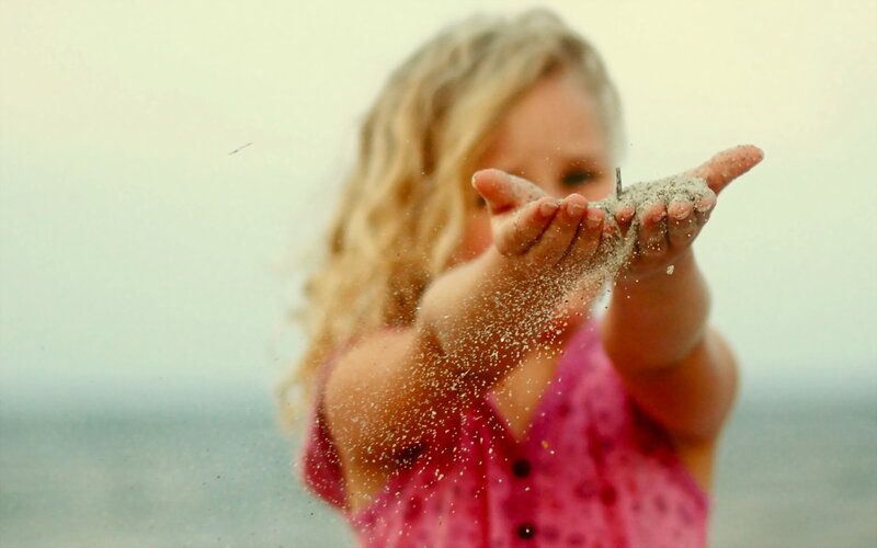 Child Holding Sand