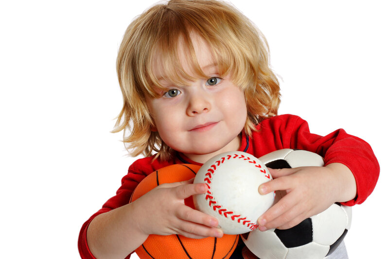 Child Holding Sports Balls