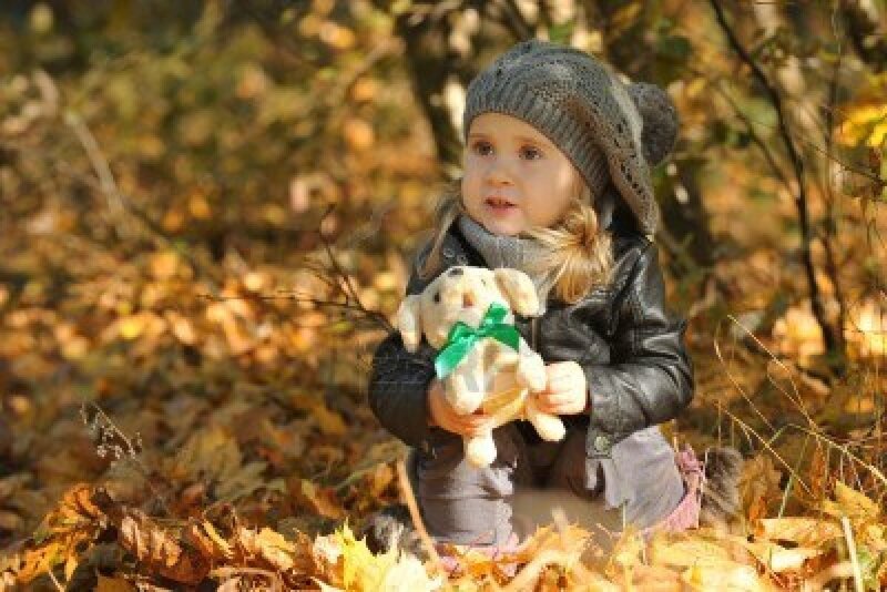 Child Holding Stuffed Animal — Brown
