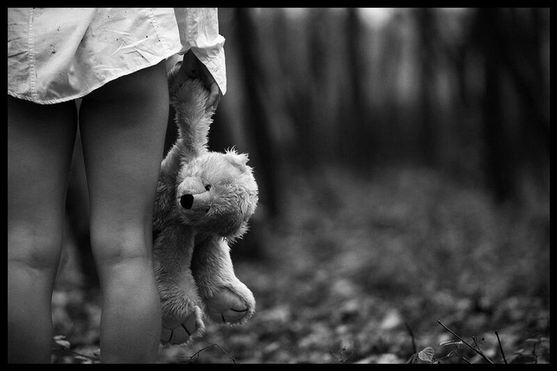 Child Holding Teddy Bear — Black