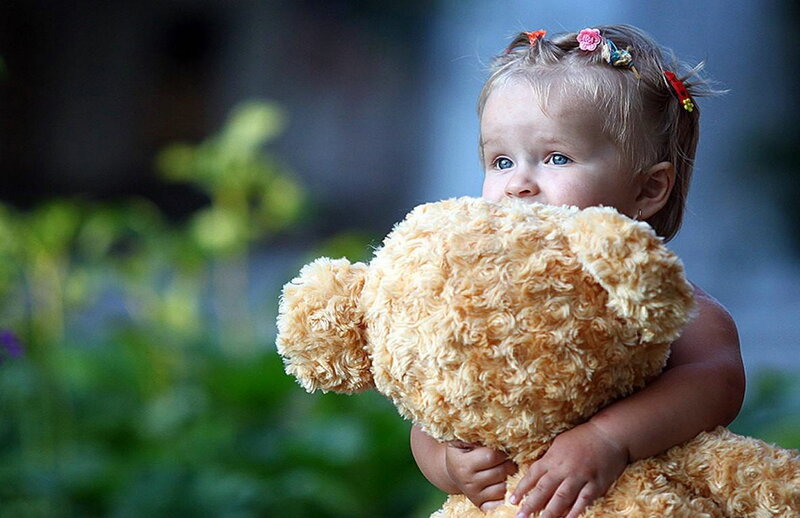Child Holding Teddy Bear — Brown