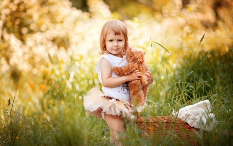 Child Holding Teddy Bear — Green, Serene, Afternoon