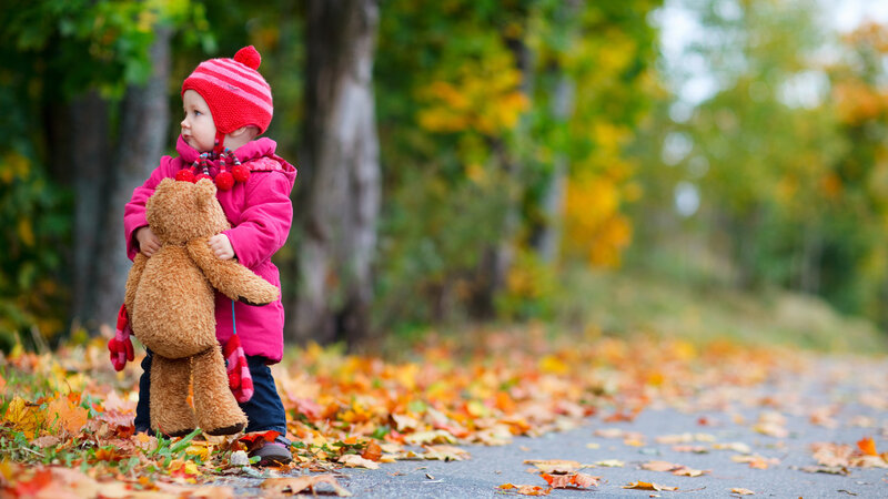 Child Holding Teddy Bear — Red