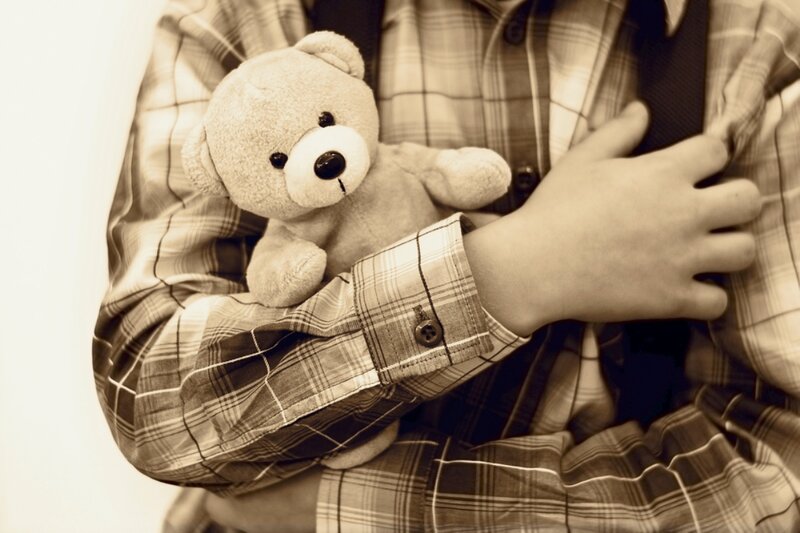 Child Holding Teddy Bear — Sepia