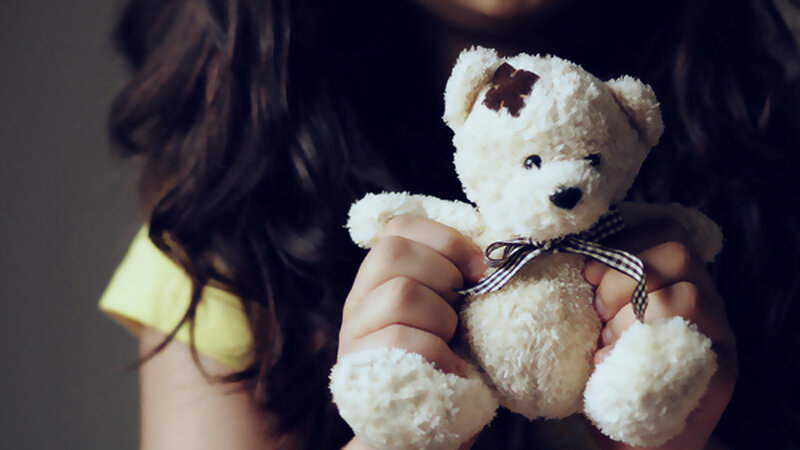 Child Holding Teddy Bear — White