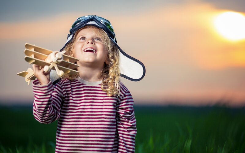 Child Holding Toy Airplane