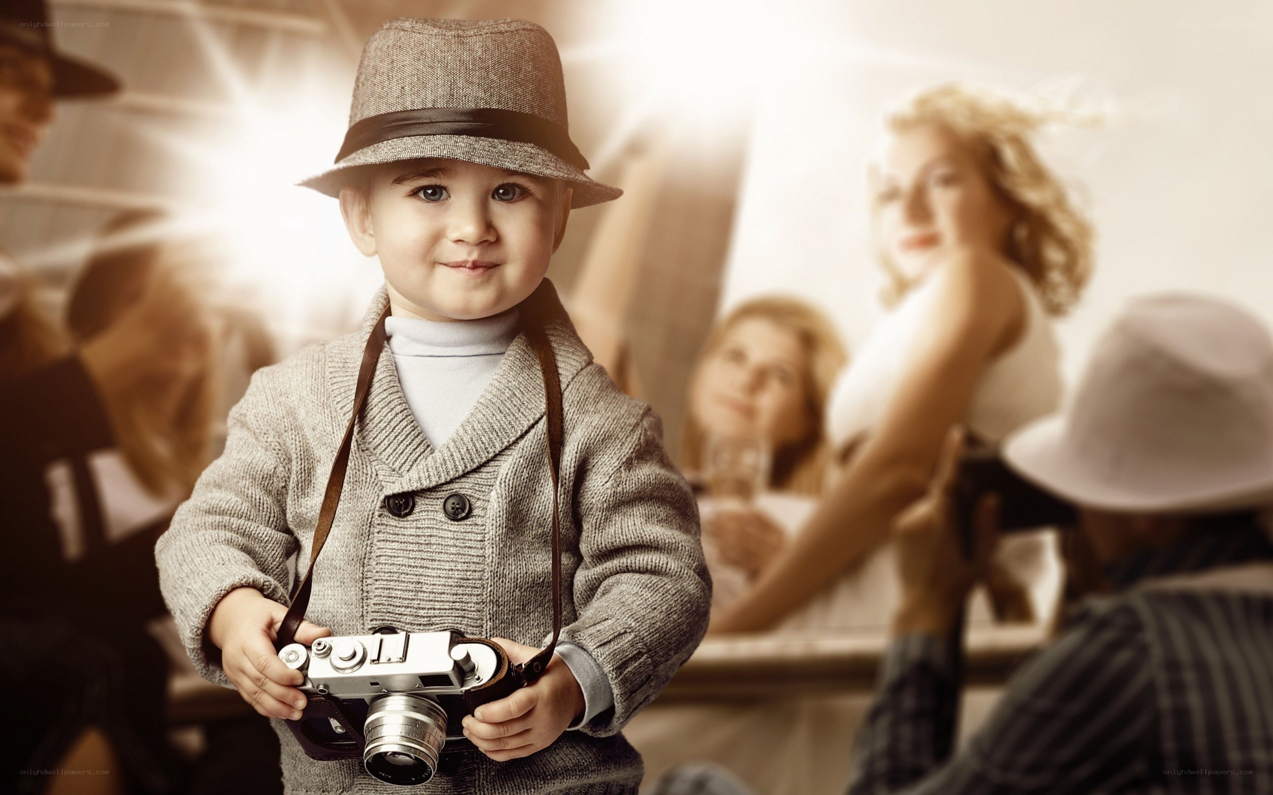 child holding vintage camera